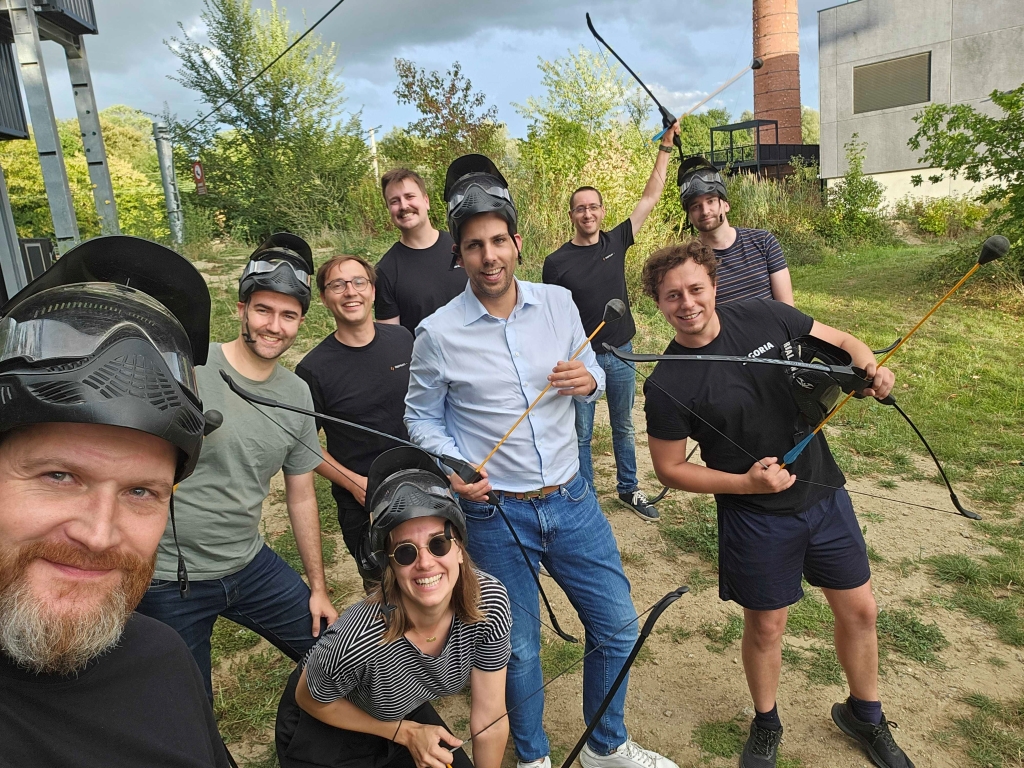 A team of colleagues posing for an action-packed group photo at an ArrowTag event, showcasing a fun and engaging team-building activity perfect for corporate events and employee engagement.