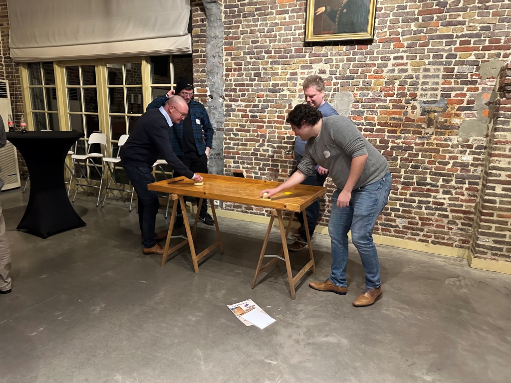 Colleagues at Itenium’s New Year Event 2025 compete in a tabletop game, focusing on strategy and precision while enjoying friendly competition.