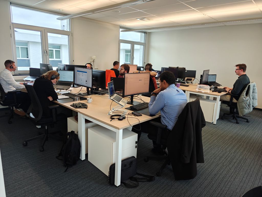 The software consultant team working side-by-side during **Office Day**, promoting **collaborative productivity** and focused **software development** in the company workspace.