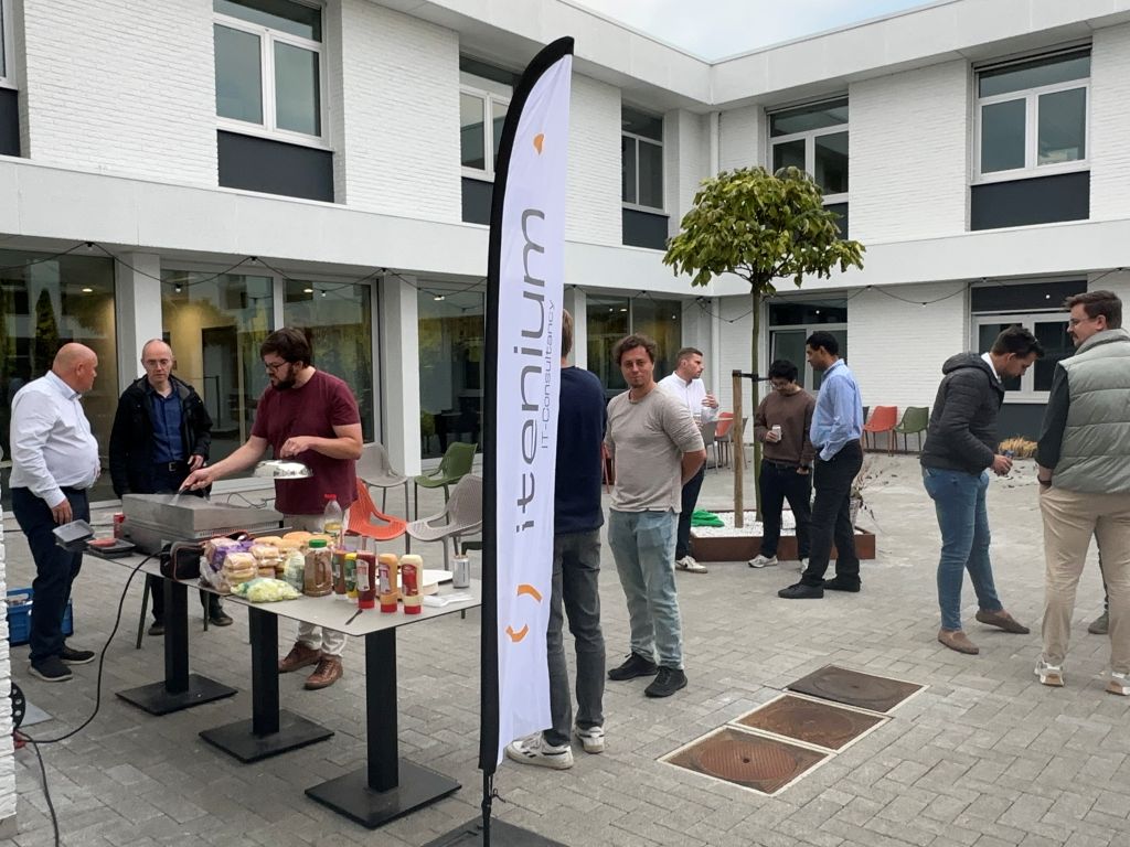 Employees enjoying a casual outdoor **afterwork networking** event, fostering **team bonding** and conversation over a BBQ, celebrating a successful **team day** of learning and fun.